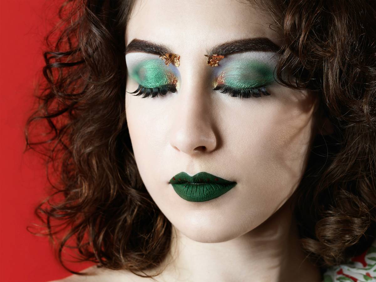 Dramatic theatrical makeup looks featuring exaggerated contouring and bold graphic lines on a model under stage lighting